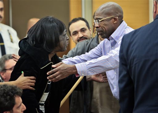 Jonathan Fleming reaches for his mother after being exonerated