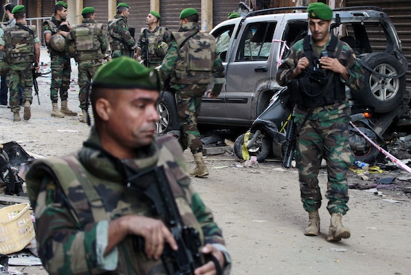 Lebanese army soldiers stand guard at the site of Thursday's twin suicide bombings in Burj al-Barajneh, southern Beirut, Lebanon, Friday, Nov. 13, 2015. Coming soon after the Islamic State group claimed the downing of the Russian plane in Egypt and deadly suicide bombings in Lebanon and Turkey, the Paris attacks appear to signal a fundamental shift in strategy toward a more global approach that experts suggest is likely to intensify. (AP Photo/Bilal Hussein, File)