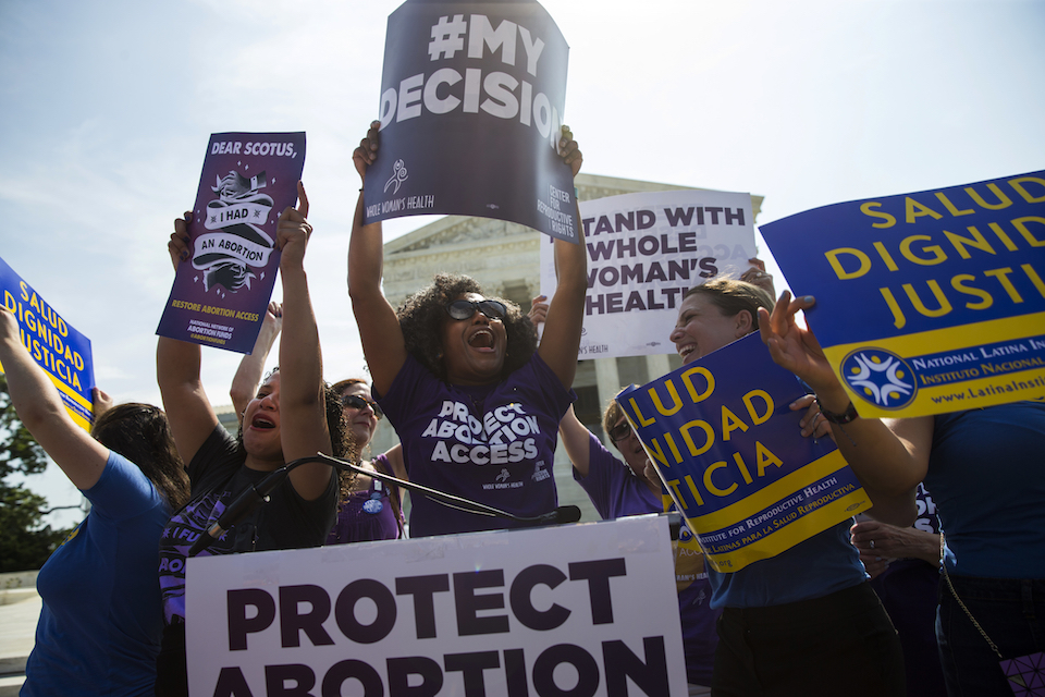 Activists celebrate during a rally on abortion rights at the Supreme Court in Washington, June 27, 2016. The tens of thousands of women flocking to Washington for a march on the day after Donald Trump's inauguration come packing a multitude of agendas, but are united in their loathing for Trump. (AP Photo/Evan Vucci, File)